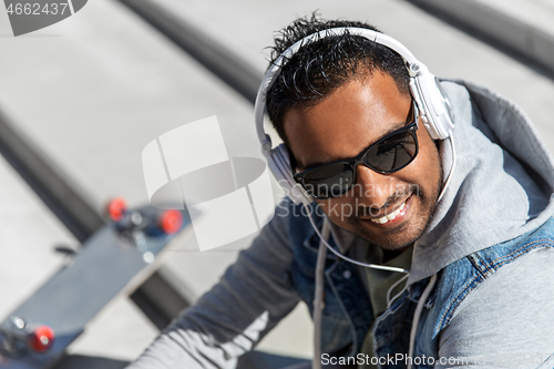 Image of indian man in headphones listening to music