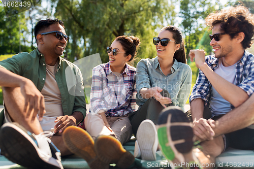 Image of friends hanging out and talking outdoors in summer