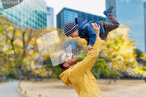 Image of father with son having fun in autumn tokyo city