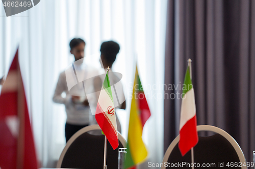 Image of flags in boardroom at international conference