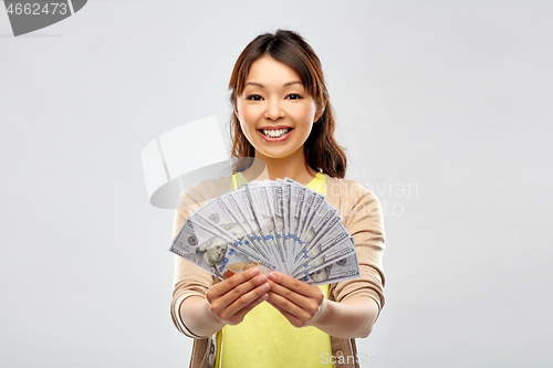 Image of asian woman with hundreds of dollar money