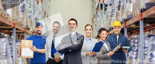 Image of group of business people and warehouse workers