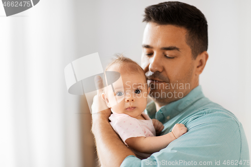 Image of middle aged father with baby daughter at home