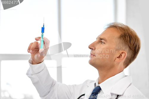 Image of smiling doctor with syringe at hospital
