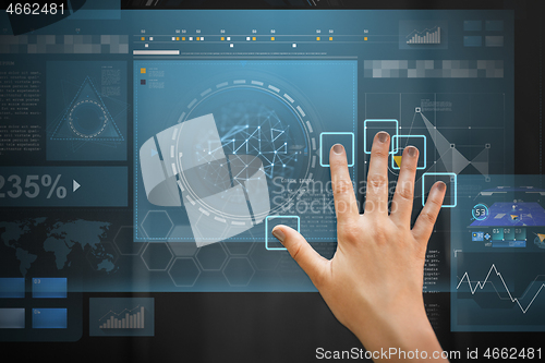 Image of hand using black interactive panel with charts