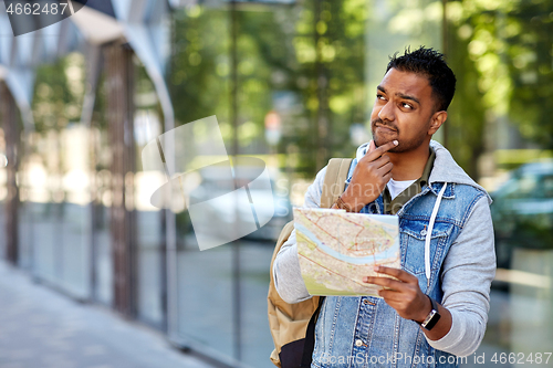 Image of indian man traveling with backpack and map in city