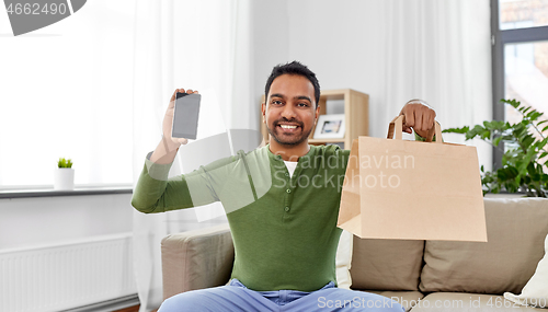 Image of indian man using smartphone for food delivery