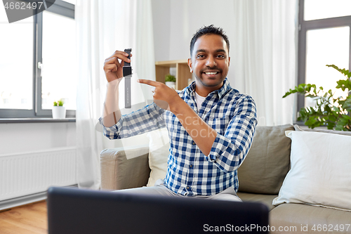 Image of male blogger recording video review of smart watch