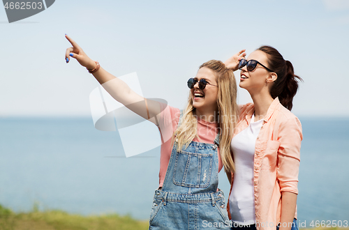 Image of teenage girls or best friends at seaside in summer