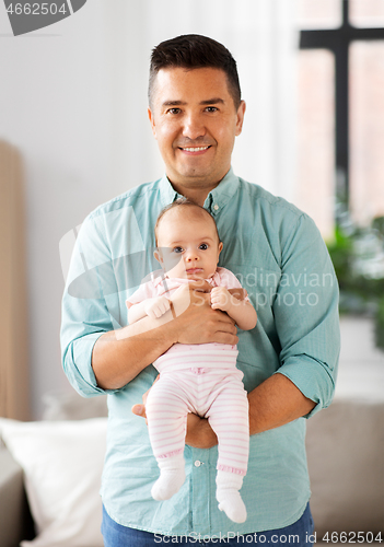 Image of middle aged father with baby daughter at home