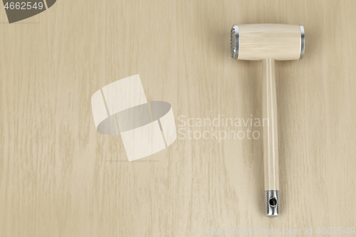 Image of Meat tenderizer on wooden table