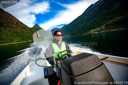 Image of Woman driving a motor boat