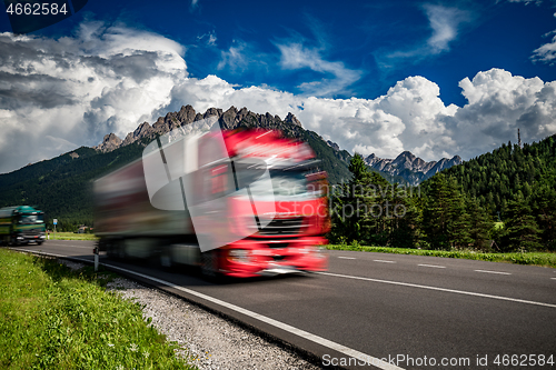 Image of Fuel truck rushes down the highway in the background the Alps. T