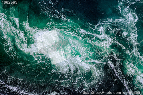 Image of Waves of water of the river and the sea meet each other during h