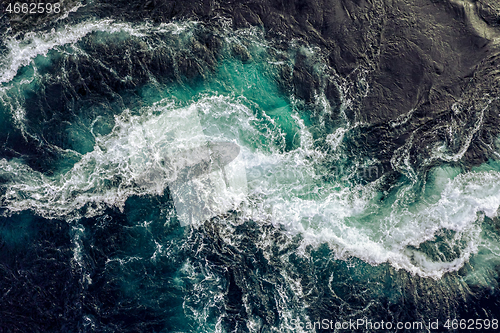 Image of Waves of water of the river and the sea meet each other during h