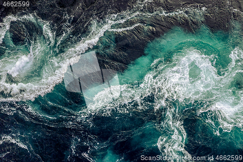 Image of Waves of water of the river and the sea meet each other during h