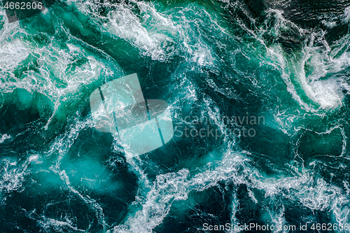 Image of Waves of water of the river and the sea meet each other during h