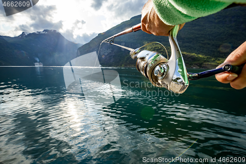 Image of Woman fishing on Fishing rod spinning in Norway.