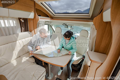 Image of Couples in RV Camper looking at the local map for the trip.