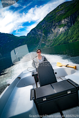Image of Woman driving a motor boat