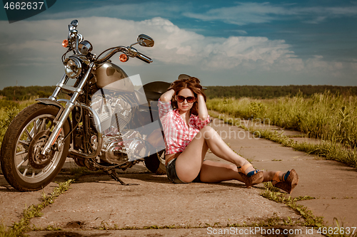 Image of Biker girl and motorcycle