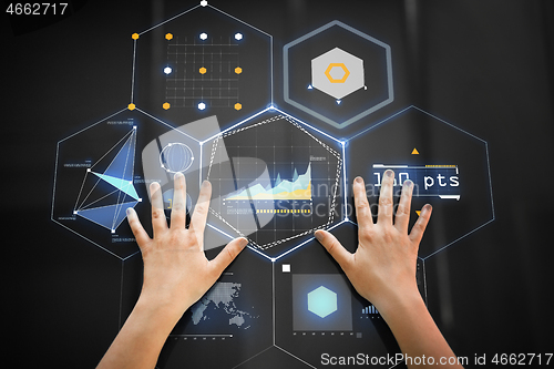 Image of hand using black interactive panel with charts