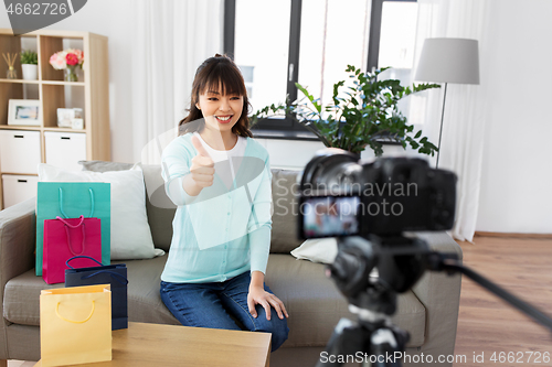 Image of female blogger making video blog about shopping