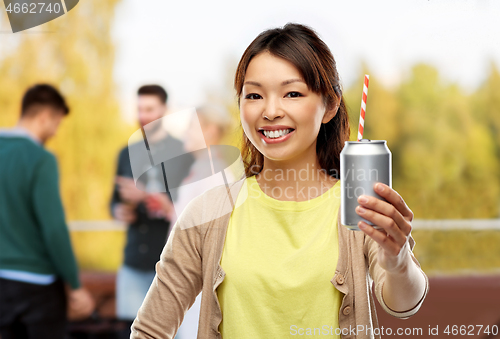 Image of asian woman with can drink over rooftop party