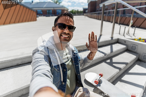 Image of indian man taking selfie on roof top