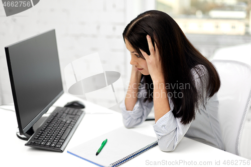 Image of stressed businesswoman with computer at office