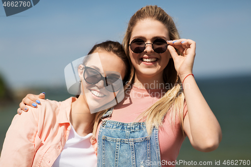 Image of teenage girls or best friends at seaside in summer