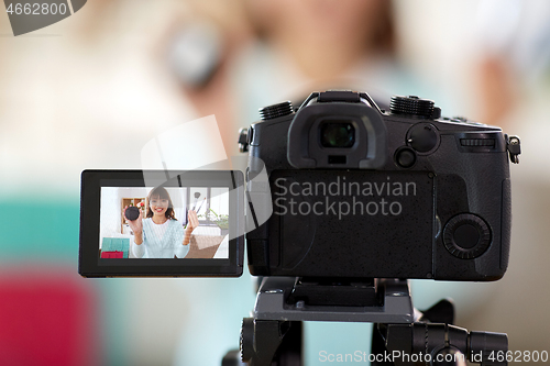 Image of female beauty blogger making video about make up