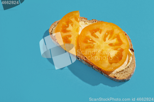 Image of slice of bread with yellow tomato