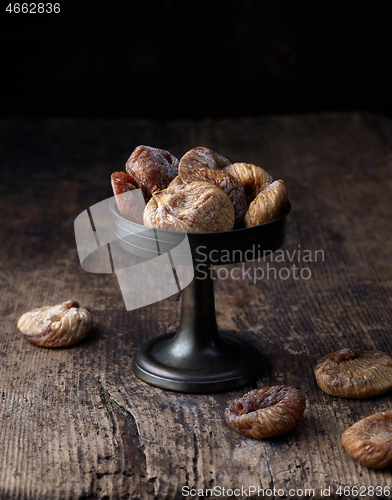 Image of dried figs on rustic wooden table