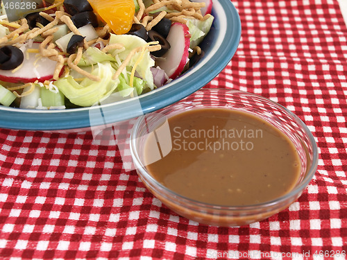 Image of Salad and Dressing on Red Checks