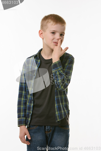 Image of Boy picking fingers in nose isolated on white background