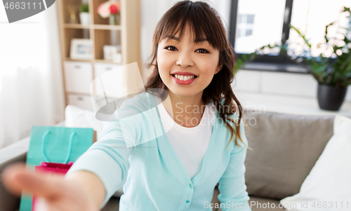 Image of asian female blogger taking video or selfie