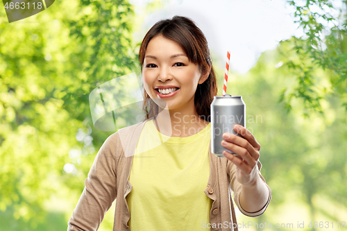 Image of asian woman with can drink over natural background