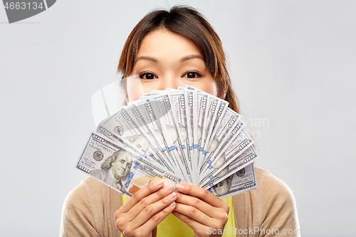 Image of asian woman with hundreds of dollar money