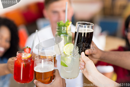 Image of friends clinking glasses at bar or restaurant