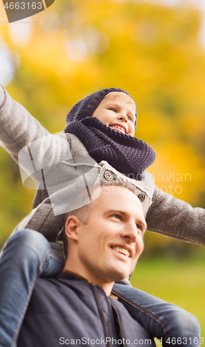 Image of happy family having fun in autumn park