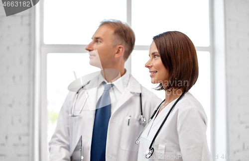 Image of smiling doctors in white coats at hospital