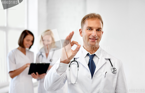 Image of smiling doctor at hospital showing ok sign