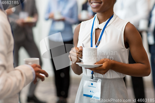 Image of business people with conference badges and coffee