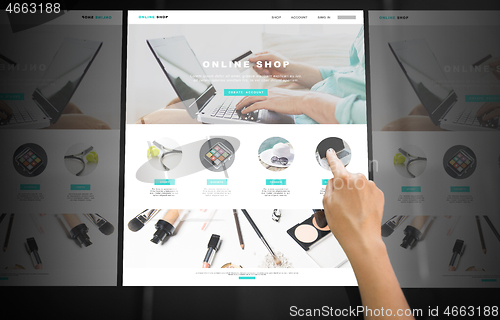 Image of hand navigating online shop on interactive panel