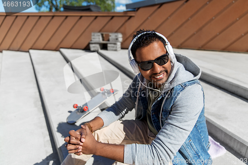 Image of indian man in headphones listening to music