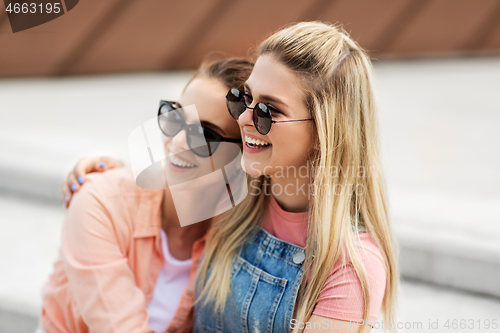 Image of teenage girls or friends on city street in summer