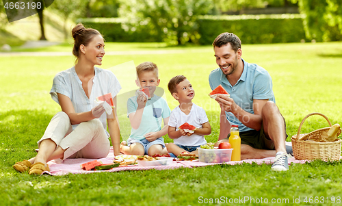 Image of happy family having picnic at summer park