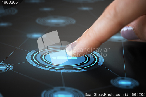 Image of finger touching network icon on interactive panel