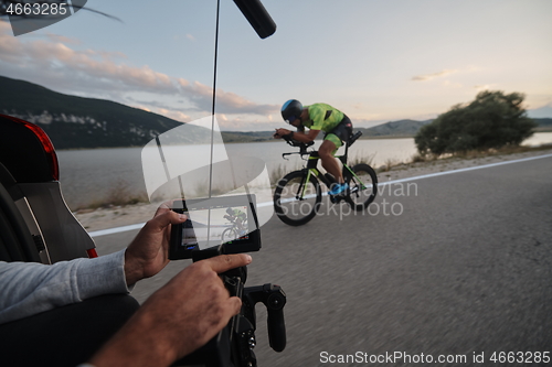 Image of cinematographer taking action shot of triathlon bike athlete